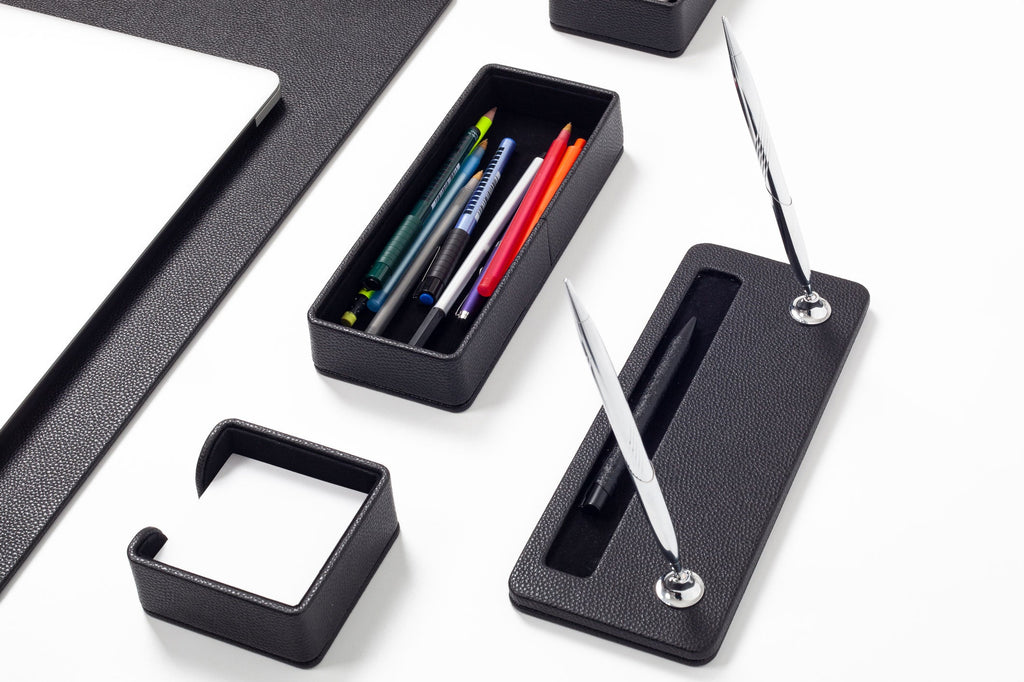 Black desk organizer with pens and a pen holder 