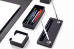 Black desk organizer with pens and a pen holder 