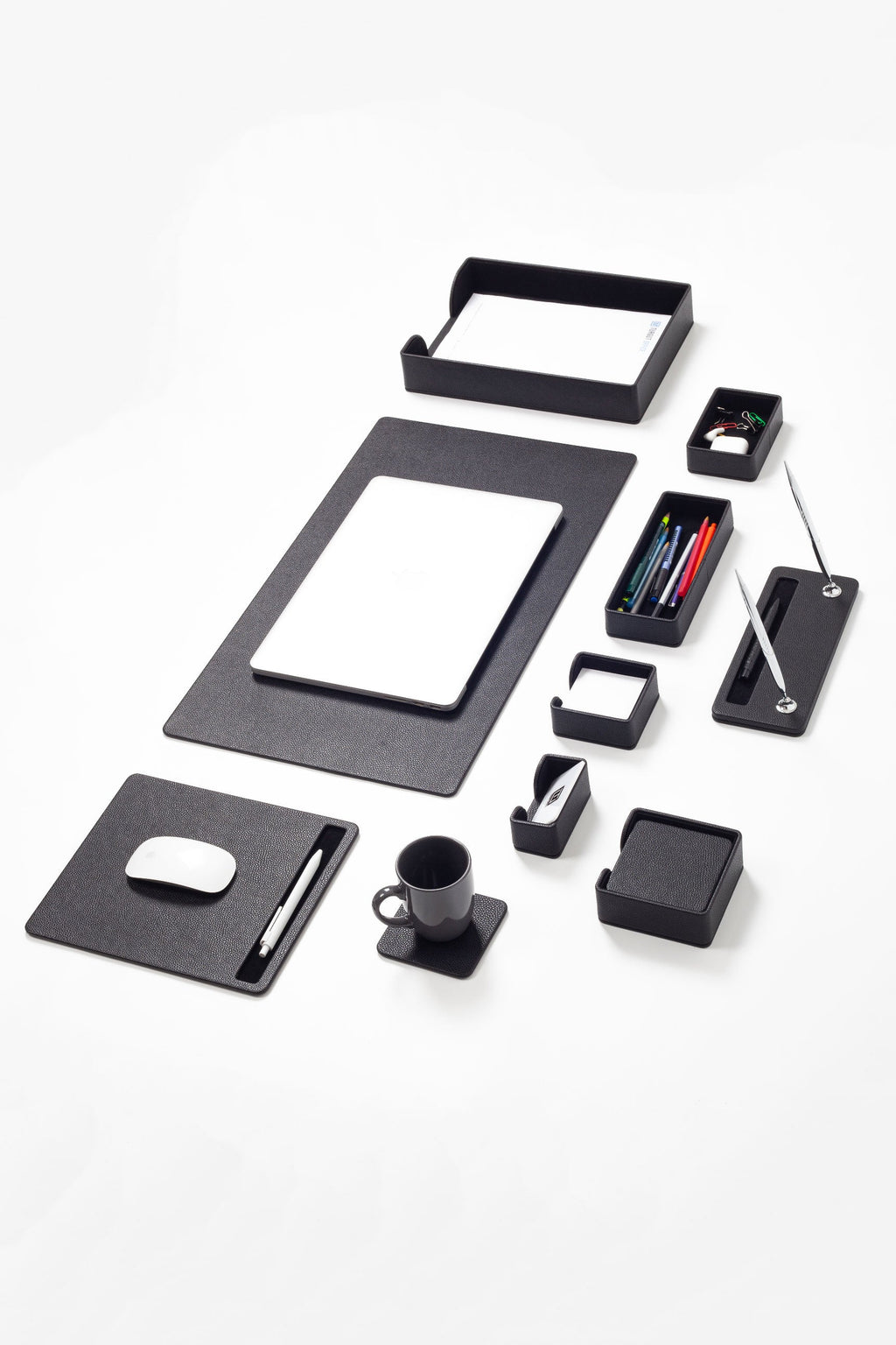 Black office supplies including a notepad, pen holder, and mouse pad on a white background
