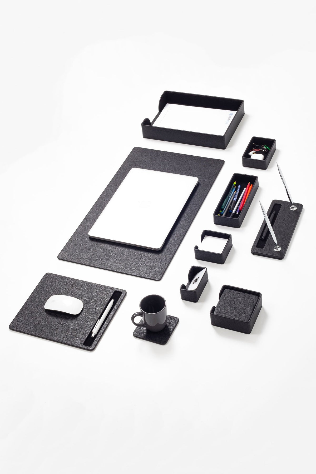 Black office supplies including a notepad, pen holder, and mouse pad on a white background