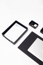 Black rectangular frame with a white sheet of paper