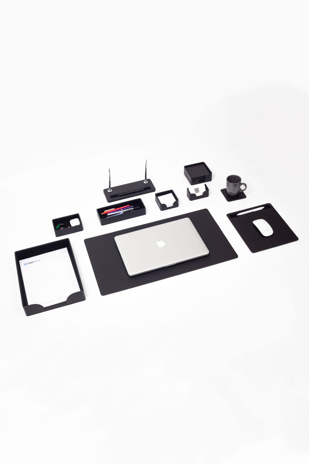 Collection of office supplies including a laptop, tablet, and various small electronic devices