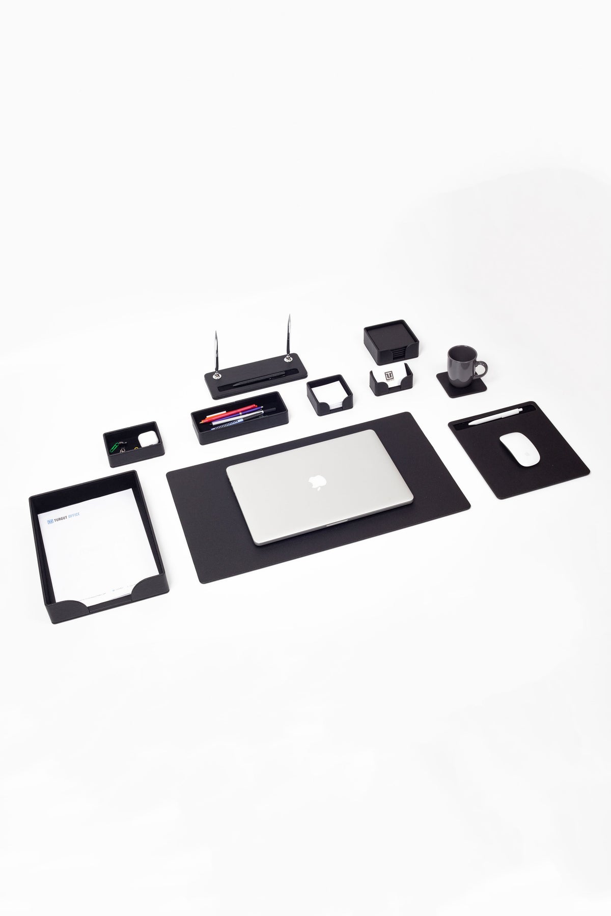 Collection of office supplies including a laptop, tablet, and various small electronic devices