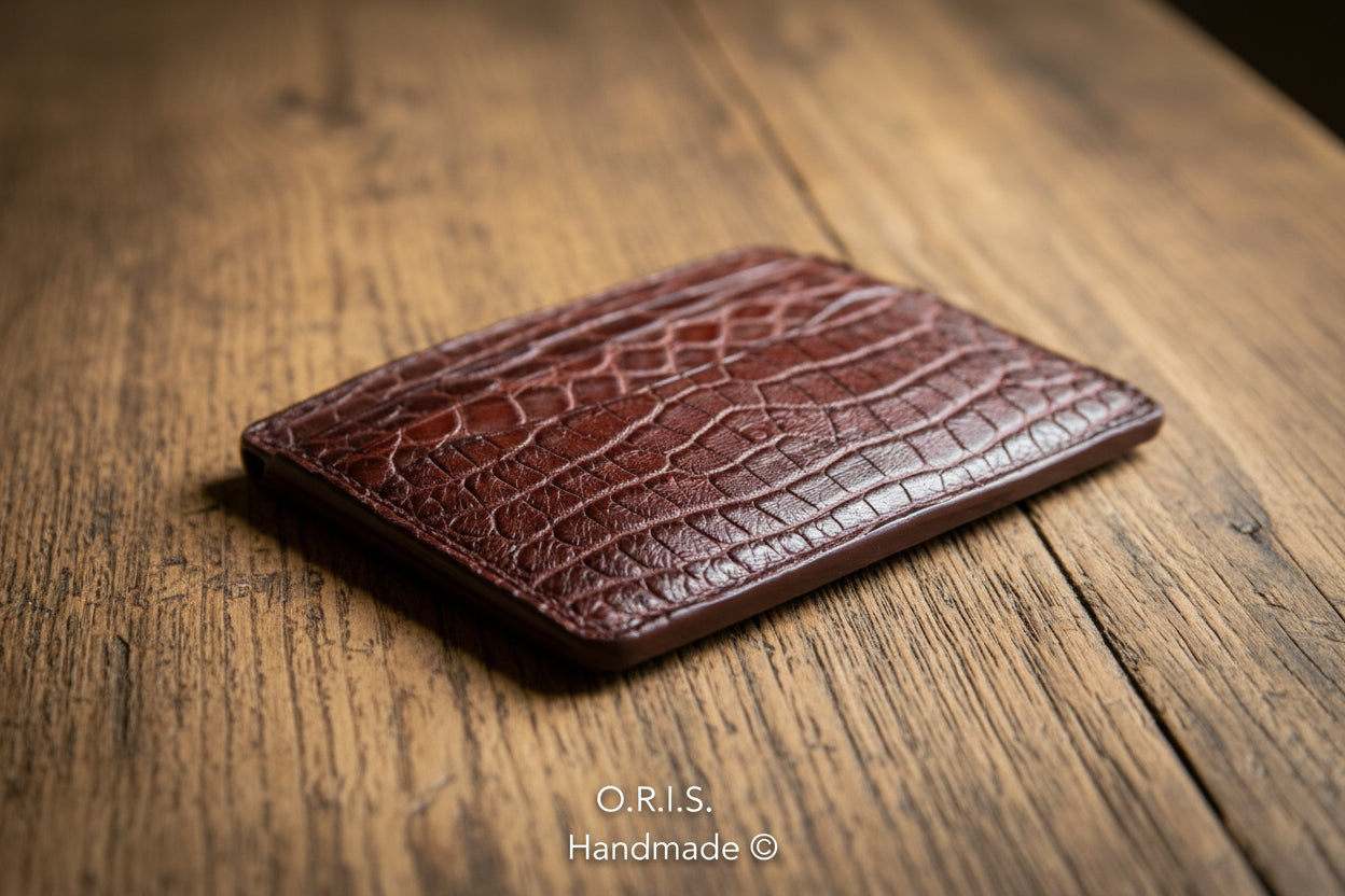 Brown leather cardholder with crocodile texture on a white background