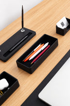 Desk organizer with pens and a phone
