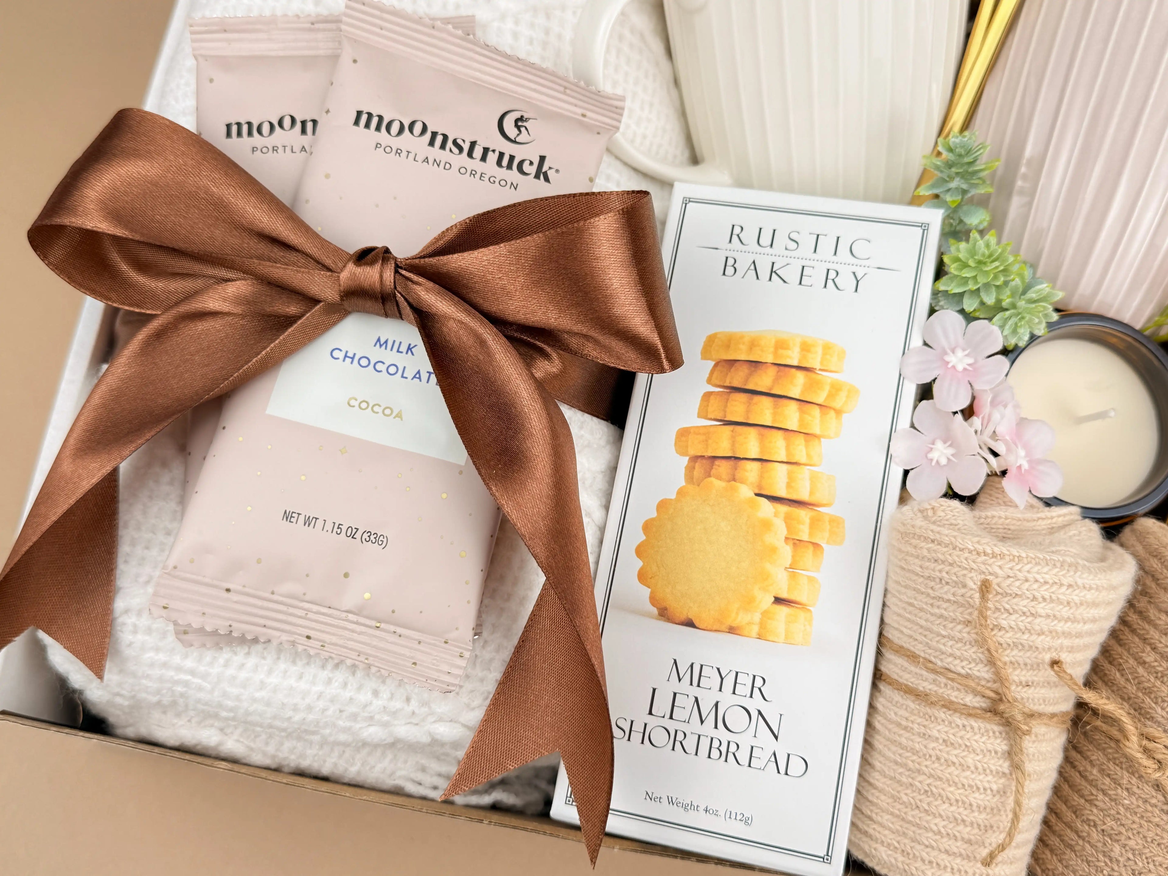 Gift set with moonstruck chocolate, a box of cookies, and decorative items.
