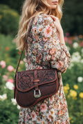 Brown leather handbag with intricate patterns