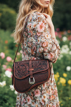 Brown leather handbag with intricate patterns
