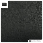 Black textured mat with a small white square corner on a black background