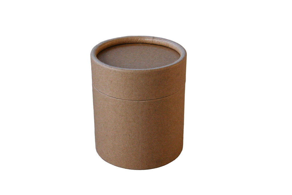 Brown paper tube with lid on a beige fabric container for cosmetic