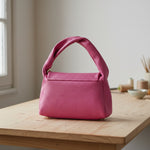 black genuine leather handbag front view with gold hardware