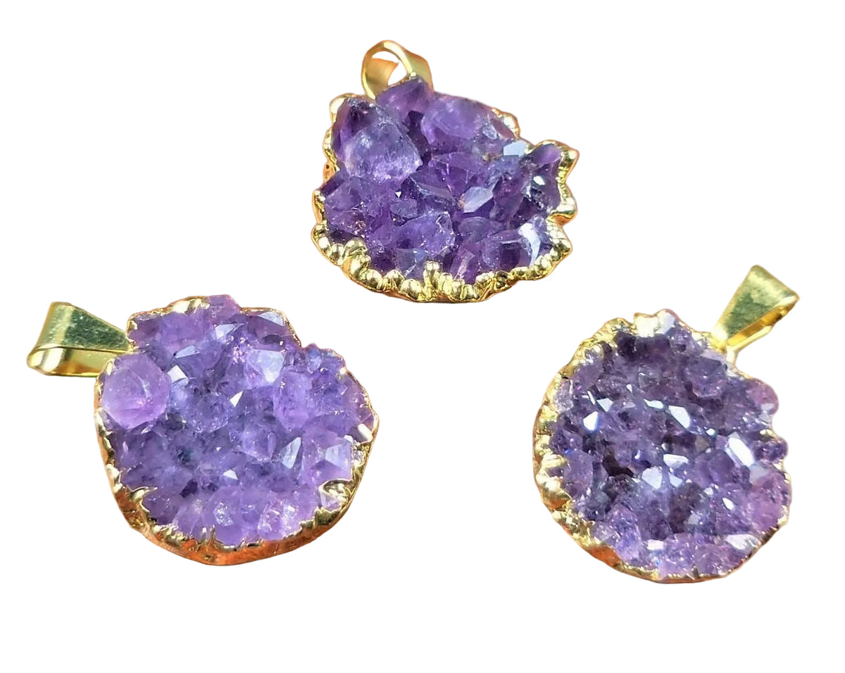 Three purple gemstone pendants with gold frames 