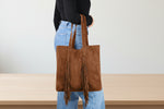 leather bucket bag with drawstring closure and leather strap
