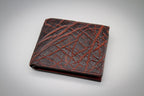 Brown leather wallet with crisscross pattern on a gray background