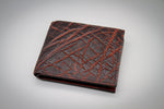 Brown leather wallet with crisscross pattern on a gray background