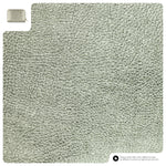 Textured green carpet sample with a small square swatch at the top left corner.